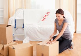 a female is preparing cardboards for the transport