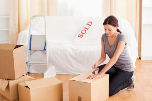 a female is preparing cardboards for the transport