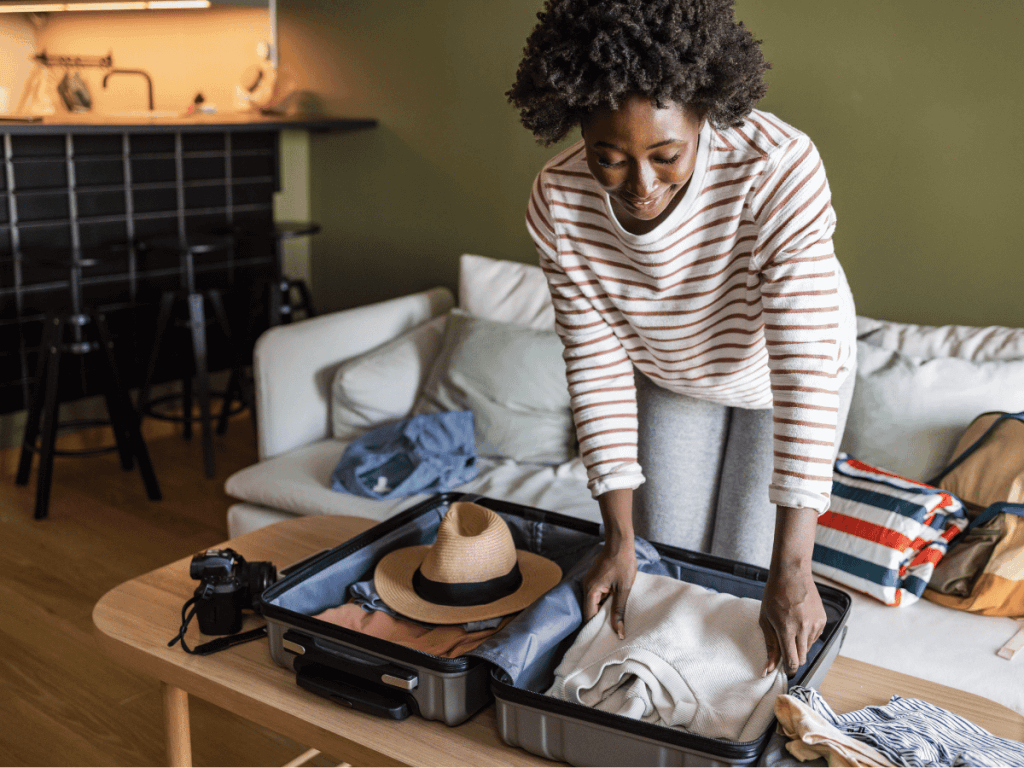 A woman is backing a suitcase for her summer holiday.