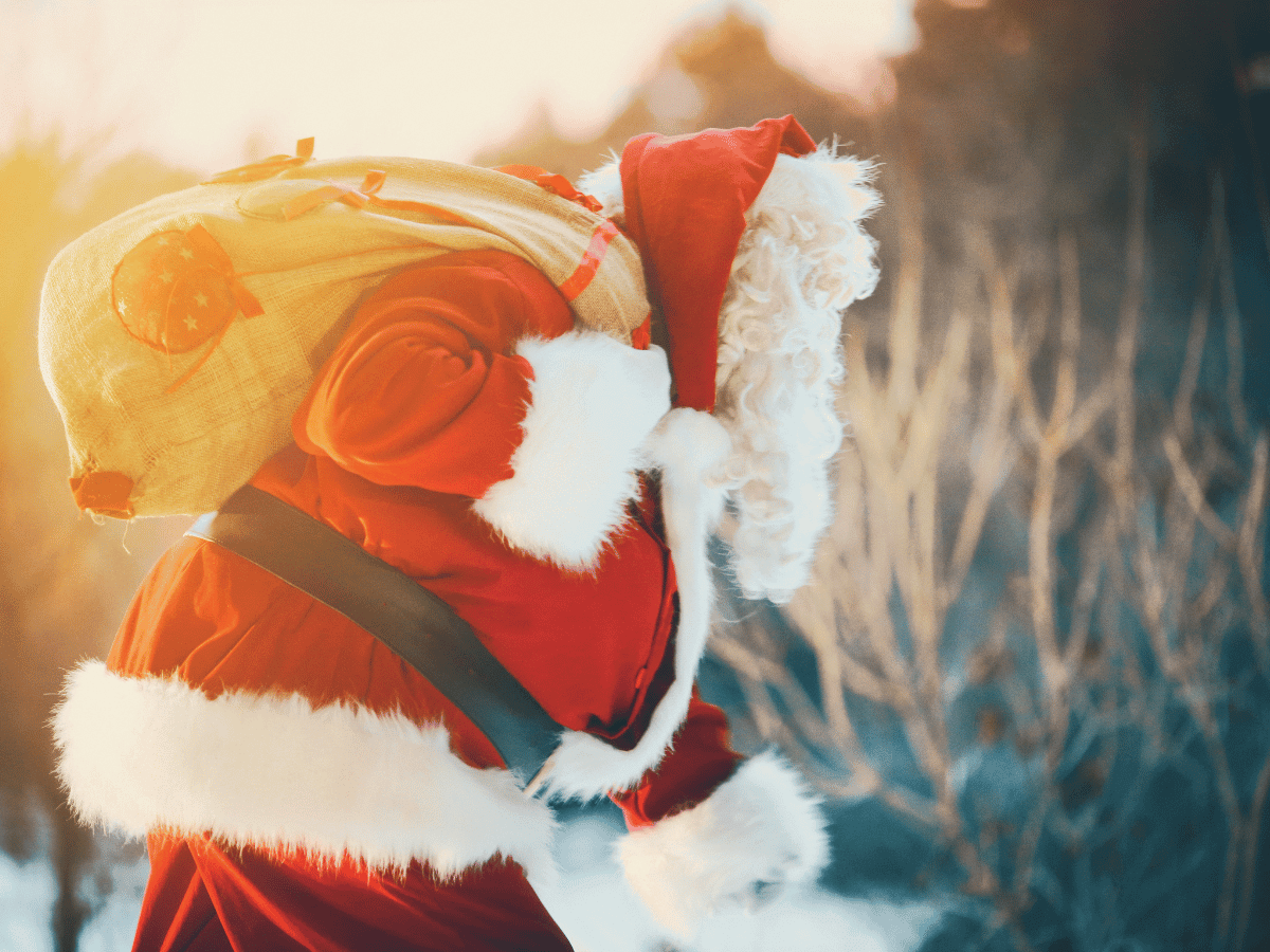 santa carries a sack through the snow to his seasonal storage unit for christmas eve